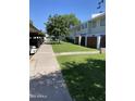 Condo exterior showing covered parking and manicured green space at 2569 W Berridge Ln # D-115, Phoenix, AZ 85017