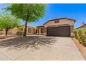 Charming single-story home featuring a well-maintained yard, desert landscaping and a spacious two-car garage at 28072 N Quartz Dr, San Tan Valley, AZ 85143