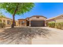 Charming single-story home featuring a well-maintained yard, desert landscaping and a spacious two-car garage at 28072 N Quartz Dr, San Tan Valley, AZ 85143