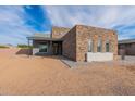 Stylish home showcasing a stone exterior, modern entryway, and desert landscape at 28421 N 59Th Way, Cave Creek, AZ 85331