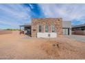 Contemporary home boasting a stone accent wall, expansive driveway, and desert surroundings at 28421 N 59Th Way, Cave Creek, AZ 85331