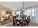 Open-concept dining room with a chandelier and large windows offering lots of light at 3202 W Knudsen Dr, Phoenix, AZ 85027