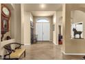 Grand foyer with tile flooring, high ceilings, and a view of the front entrance at 3202 W Knudsen Dr, Phoenix, AZ 85027
