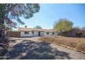 Well-maintained single story home features a large drive and attractive landscaping, perfect for a Gathering at 3249 E Sunnyside Ln, Phoenix, AZ 85032