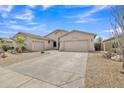 Attractive home featuring a circular driveway, desert landscaping, and a neutral color scheme at 43271 W Little Dr, Maricopa, AZ 85138