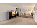 Comfortable living room with plush sofa and entertainment center, flooded with light at 4333 E Desert Cactus St, Phoenix, AZ 85032