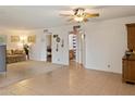 Spacious living room with carpet and tile flooring featuring a ceiling fan at 4333 E Desert Cactus St, Phoenix, AZ 85032
