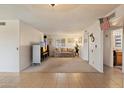 Bright living room with carpet and neutral paint, featuring a large window at 4333 E Desert Cactus St, Phoenix, AZ 85032