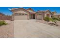 Inviting home with a spacious driveway, two-car garage, and additional one-car garage at 44574 W Garden Ln, Maricopa, AZ 85139