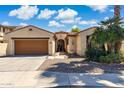 Charming home exterior featuring a well-manicured yard, and a two-car garage, creating excellent curb appeal at 455 W Honeysuckle Dr, Chandler, AZ 85248