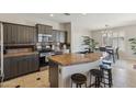 Modern kitchen with granite countertops, stainless steel appliances, and an island with bar seating at 455 W Honeysuckle Dr, Chandler, AZ 85248