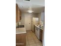 Functional kitchen with appliances, ample cabinet space, and tile flooring at 4628 E Wood St, Phoenix, AZ 85040