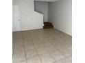 Bright living room featuring tile flooring, stairs, and neutral walls, a perfect blank canvas at 4628 E Wood St, Phoenix, AZ 85040