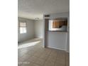 Well-lit living room with large window and breakfast bar, perfect for dining at 4628 E Wood St, Phoenix, AZ 85040