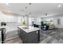 Modern kitchen with stainless steel appliances, a large island, and an open concept design to the living room at 505 S Soho Ln # 30, Chandler, AZ 85225