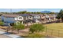 Row of modern two-story homes, showcasing a community-oriented design, landscaping, and mountain views at 512 S Soho Ln # 8, Chandler, AZ 85225