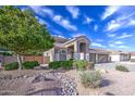 The home has a well-manicured lawn and beautiful landscaping, adding to its curb appeal at 6030 W Topeka Dr, Glendale, AZ 85308
