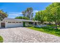 Lovely home with white exterior, lush lawn, and a spacious driveway leading to the garage at 6837 E Lafayette Blvd, Scottsdale, AZ 85251