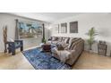 Comfortable living room with a plush sectional sofa, a large window, and tasteful decor creating a cozy atmosphere at 928 W Natal Ave, Mesa, AZ 85210