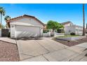 Single-Gathering home with a two-car garage and low maintenance desert landscaping at 10102 E Dreyfus Ave, Scottsdale, AZ 85260