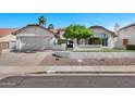Charming single-Gathering home featuring a well-manicured lawn and a two-car garage at 10102 E Dreyfus Ave, Scottsdale, AZ 85260