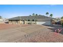 Inviting single-story home boasts well-maintained landscaping, a spacious driveway, and a two-car garage at 1057 S 74Th St, Mesa, AZ 85208