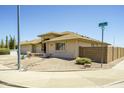 A beautifully maintained home with manicured desert landscaping and three car garage at 11447 E Mendoza Ave, Mesa, AZ 85209