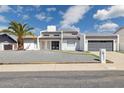 Modern home featuring a xeriscaped front yard, fresh white paint, and a gray garage door at 15027 N 19Th Way, Phoenix, AZ 85022