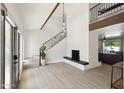 Bright living room featuring modern fireplace, hardwood floors, and black metal staircase at 15027 N 19Th Way, Phoenix, AZ 85022