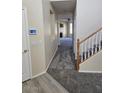 Entryway with carpeted floors, security system and access to the living room at 1794 N Agave St, Casa Grande, AZ 85122