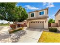 Inviting two-story home with a spacious garage, well-maintained landscaping, and neutral exterior paint at 1944 N Lazona Dr, Mesa, AZ 85203