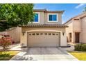 Inviting two-story home with a spacious garage, well-maintained landscaping, and neutral exterior paint at 1944 N Lazona Dr, Mesa, AZ 85203