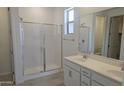 Stylish bathroom featuring a double vanity and glass enclosed shower at 22400 W Monona Ln, Surprise, AZ 85387