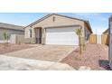 Attractive home featuring a 2-car garage, a welcoming entrance, and decorative rock landscaping at 24610 W Bowker St, Buckeye, AZ 85326