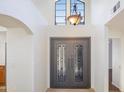Home foyer featuring a decorative light fixture, and an ornate, double-door entryway at 2663 N Carriage Ln, Chandler, AZ 85224