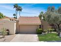 Single-story house displaying a tile roof, a neutral-colored exterior, and desert landscaping at 2663 N Carriage Ln, Chandler, AZ 85224