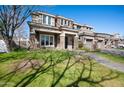 Beautiful two-story home featuring stone detailing, three-car garage, lush lawn and shade, offering a luxurious appeal at 2988 E Comstock Dr, Gilbert, AZ 85296