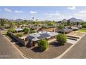 This property features solar panels, mature trees, and a fenced yard at 3002 E Montecito Ave, Phoenix, AZ 85016