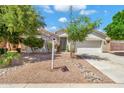 Charming home exterior featuring desert landscaping, a well-maintained lawn, and a two-car garage at 3044 E Sparrow Pl, Chandler, AZ 85286