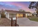 Inviting single-story home with a covered carport and a well-kept front yard, showcasing its curb appeal at 317 E Belmont Ave, Phoenix, AZ 85020