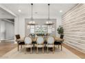 Formal dining room with decorative lighting, wood floors, and seating for six at 3648 E Fargo St, Mesa, AZ 85205