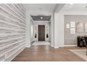 Elegant entryway featuring wood floors, accent wall, and views into the home at 3648 E Fargo St, Mesa, AZ 85205