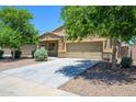 Inviting single-Gathering home boasting a well-maintained lawn, long driveway, and appealing exterior at 38086 W Isabella Ln, Maricopa, AZ 85138