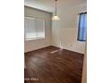 Bright, spacious room featuring hard surface floors, neutral walls, and large window for natural light at 38086 W Isabella Ln, Maricopa, AZ 85138