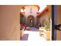 Inviting courtyard with desert landscaping, stylish furniture, and a charming entrance to the home at 4050 N Terra Mesa Cir, Mesa, AZ 85207