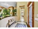 Inviting foyer featuring decorative tile flooring, an ornate bench, and views into the home at 4050 N Terra Mesa Cir, Mesa, AZ 85207