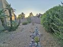 View of the backyard featuring desert landscaping, a statue, and lush greenery at 4116 E Lupine Ave, Phoenix, AZ 85028