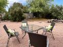 A peaceful backyard sitting area under mature trees provides a relaxing outdoor space at 42 W Thomas Ln, Tempe, AZ 85281
