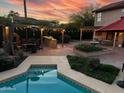 Outdoor oasis featuring a covered patio, a hot tub, and lush landscaping at 4441 E Sunnyside Ln, Phoenix, AZ 85032