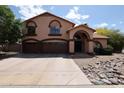 Charming two-story home featuring a terracotta roof and three-car garage at 4441 E Sunnyside Ln, Phoenix, AZ 85032